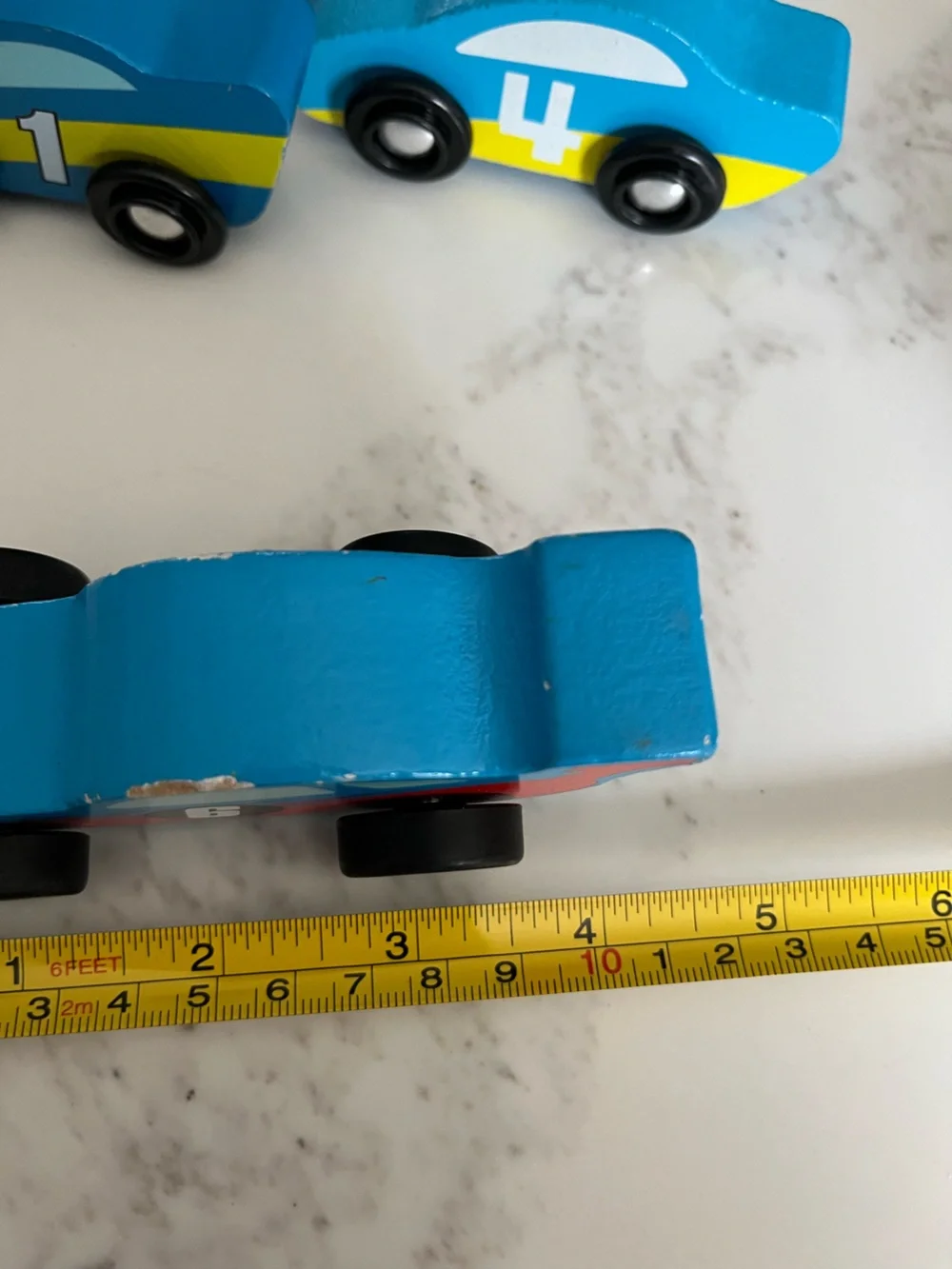 8 wooden racing cars.   Cars Number 1-4 are Melissa & Doug.